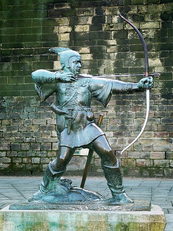 A statue depicting Robin Hood poised with a bow and arrow