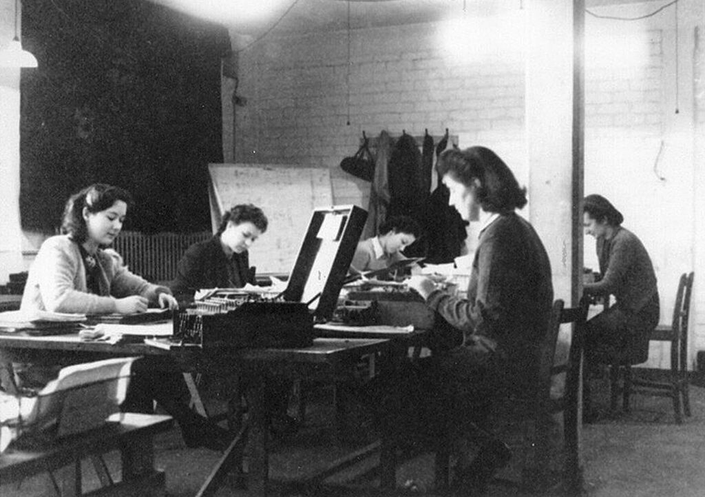 Black and white photograph showing women at work in the 'duddery' in Block D/Hut 6 at Bletchley Park