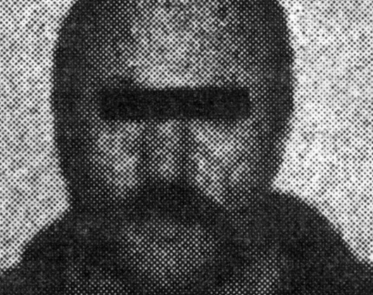A blurry image of a bearded man, eyes blanked out - mugshot of Janusz Prasol, known as 